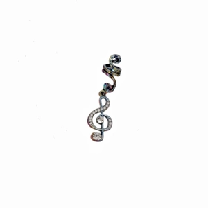 Detailed view of silver treble clef hair clip with sparkling rhinestones on white base