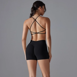 Detail of cross-back sports bra and high-waisted scrunch butt shorts in black set