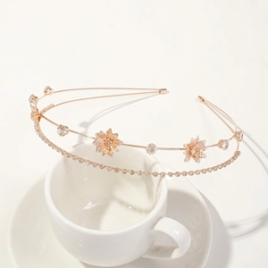 Detailed macro of rose gold double-layer headband with hollow flowers and rhinestones