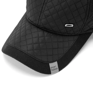 Detail of winter baseball cap showing quilted texture and silver metal decoration