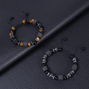 Adjustable tiger eye and lava stone beaded bracelets for men on black leather background
