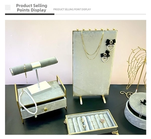 Modern grey velvet jewelry display set with gold metal frames for necklaces and rings