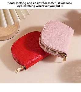 Close-up of red and light pink pebble leather credit card wallets with gold zippers