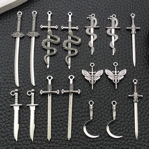 Macro view of assorted silver zinc alloy sword and dagger charms for DIY jewelry making