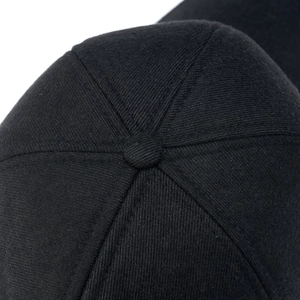 Macro shot of black cotton baseball cap top button and detailed six-panel stitching
