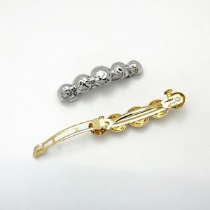 Minimalist metal ball spring hair clips in gold and silver finish on white background