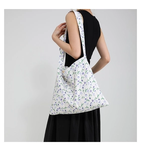 Detail shot of large floral canvas tote bag showing shoulder strap and floral print