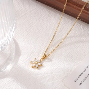 Elegant gold titanium sunflower necklace with marquise-cut zircon petals on white fabric