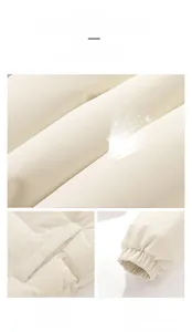 Detail of cream quilted puffer jacket showing waterproof fabric, pockets and elastic cuffs