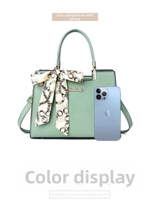 Mint green textured faux leather handbag size comparison with smartphone and silk scarf