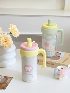 Close-up of pastel insulated tumblers with puppy graphics, handle and straw cover