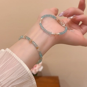 Detail of beaded bracelet with light blue crystal beads on model wrist for daily wear