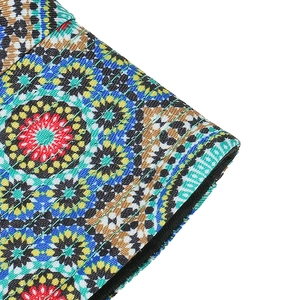 Close-up of bohemian bucket hat showing colorful geometric print and fine quilting stitching
