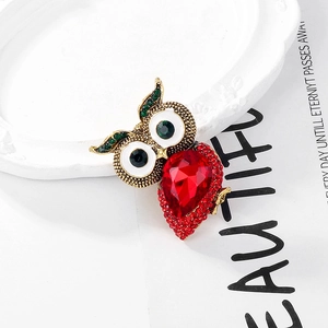 Retro golden owl brooch with oversized red teardrop crystal and sparkling rhinestones