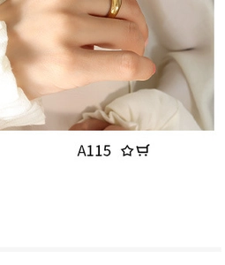 Close-up of minimalist gold-plated square pendant ring worn on finger with soft lighting