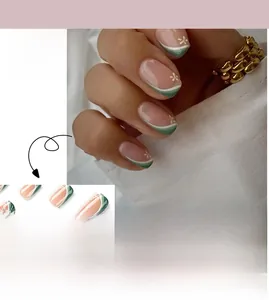 Close-up of green and white French press-on nails with delicate floral accents
