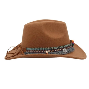 Detail of tan felt cowboy hat with colorful woven band, tassels and silver coin pendant
