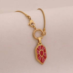 Vintage gold snake chain necklace with a red and pink enamel hexagon sunburst pendant