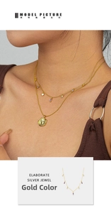 Detail of S925 silver layered necklace with purple zircon and gold coin pendant