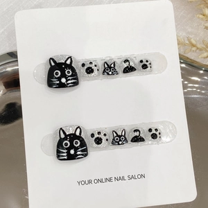 Handmade black and white cat toe press-on nails with silver glitter and paw prints