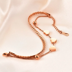 Elegant rose gold double-layer heart bracelet featuring sleek snake and box chain styles