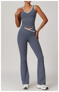 Detail of high-waist yoga set with cross-waist design and contrast color trim in blue