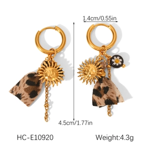Detail of sun mask and leopard print earrings with 1.4cm diameter and 4.5cm length measurements