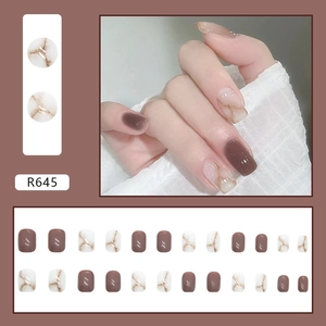 Short round marble pattern press-on nails in deep bean paste and coffee brown shades