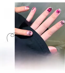 Detail of pink heart graffiti press-on nails with black hand-drawn LOVE lettering