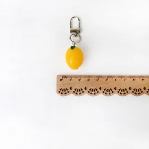 Cute yellow lemon fruit keychain with green leaf and silver metal clip for keys