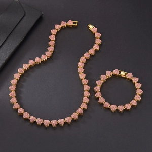 Detailed set of gold cuban link necklace and bracelet with pink heart-shaped stones