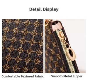 Close-up of brown textured leather bag with gold clover prints and smooth metal zipper