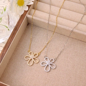 Elegant gold and silver flower pendant necklace with cubic zirconia on a luxury chain