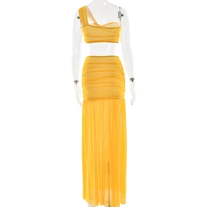 Detail of yellow one-shoulder crop top and ruched mesh skirt on model with white background