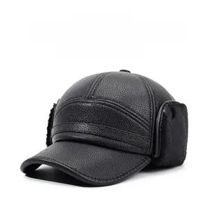 Detailed view of the thick black leather texture and soft faux fur lining on ear flaps