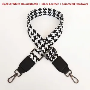 Close-up of houndstooth replacement strap with gunmetal swivel hooks and black leather