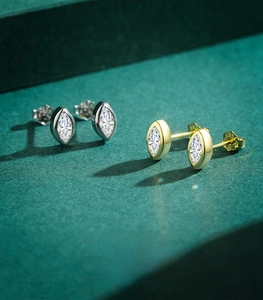 Macro shot of marquise-cut cubic zirconia studs in silver and gold 925 sterling silver