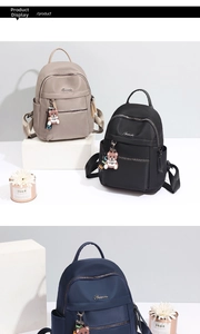 Oxford fabric backpack detail in khaki black and blue with metal zippers and cute charms