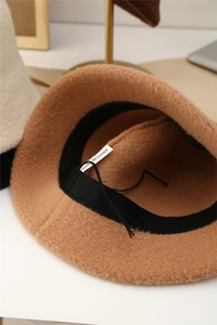 Detail view of the soft brown fabric texture and adjustable inner strap of the bucket hat
