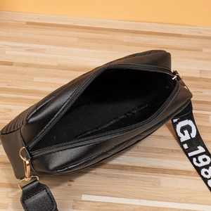 Top view of black quilted crossbody bag showing spacious interior and golden zipper