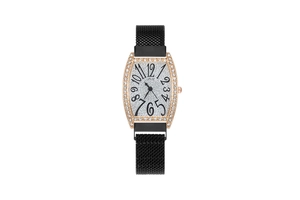 Macro detail of tonneau watch face with pavé diamond bezel and magnetic mesh strap