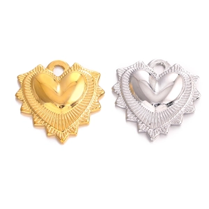 Minimalist stainless steel heart pendants with textured sunburst design in gold and silver