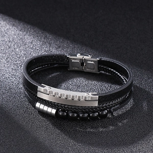Macro shot of multi-layer black leather bracelet with stainless steel beads and clasp