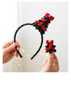 Detail of green velvet Christmas tree headband and clip with gold star accents