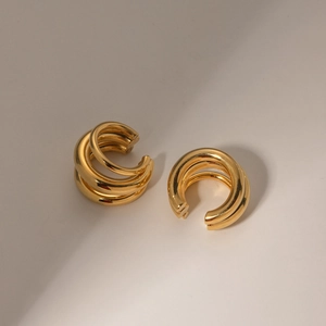 Detailed view of polished 18K gold-plated stainless steel triple-layer hoop clip earrings