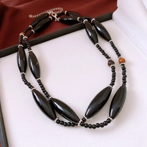 Detail of tiger eye glass beaded necklace with lobster clasp and adjustable metal chain