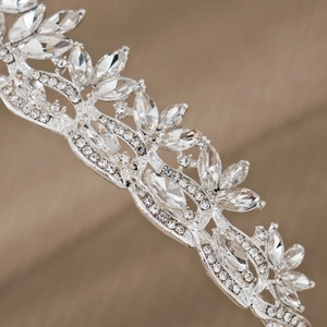Exquisite silver bridal tiara featuring leaf motifs and sparkling rhinestone crystals