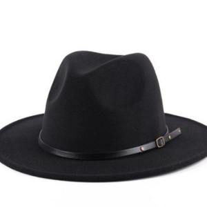 Classic black fedora hat with a leather decorative band and bronze buckle on white background