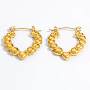 Macro detail of high-quality gold plated heart beaded hoop earrings in stainless steel