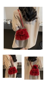 Detail showing plush red faux fur texture and leather strap of the stylish bucket bag